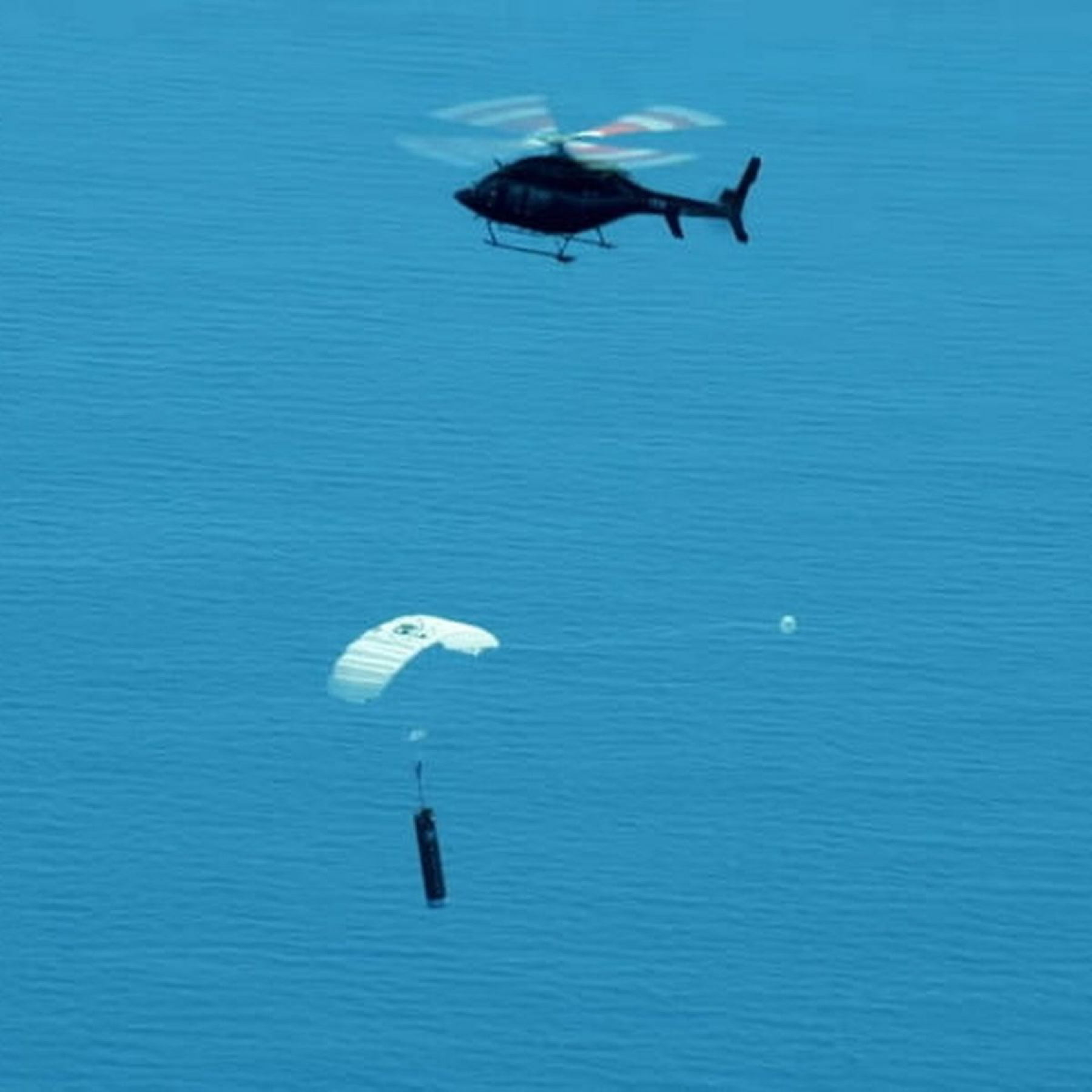 Helicopter catches returning booster over the Pacific