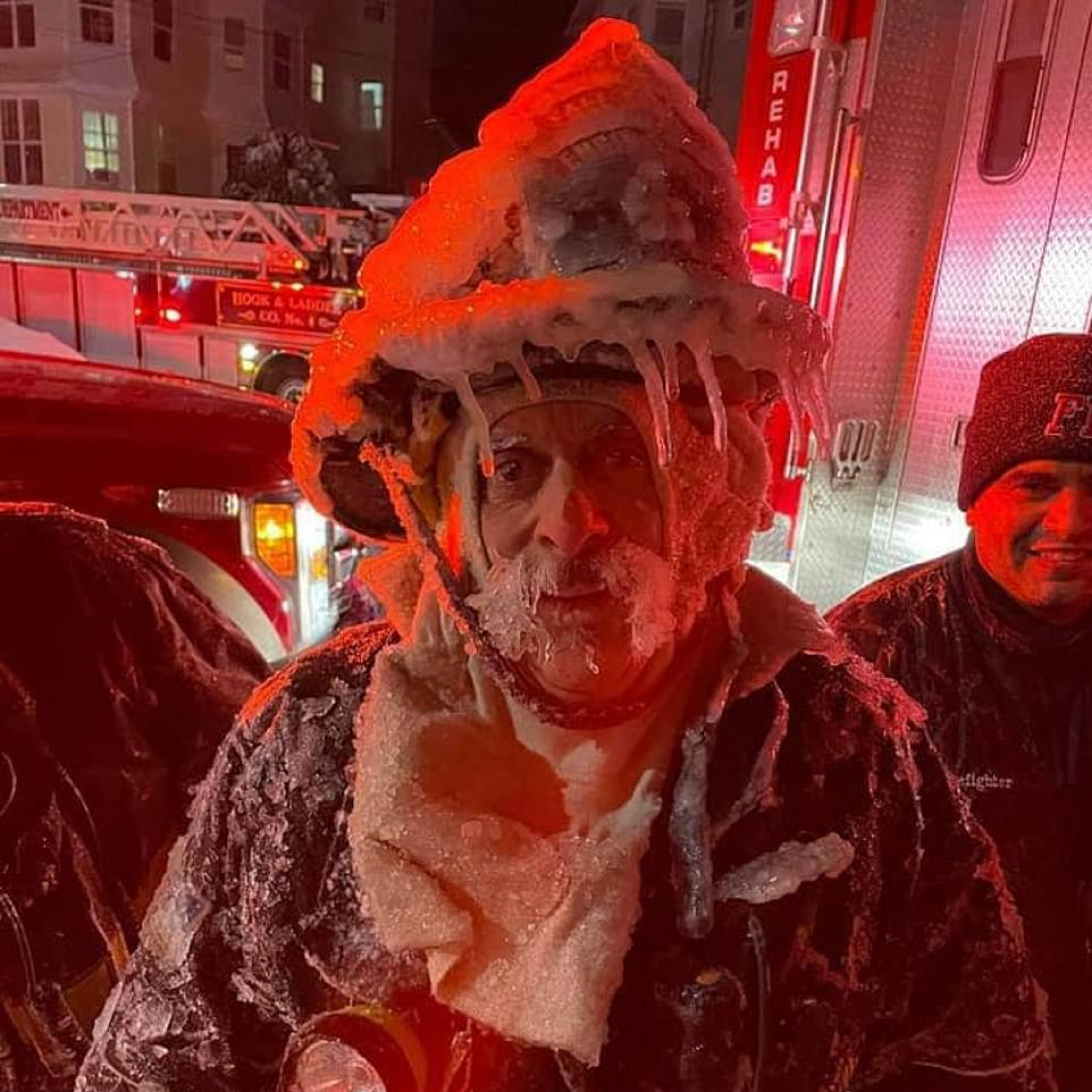 Firefighter is seen covered with icicles after fighting blaze during brutal Winter Storm Kenan