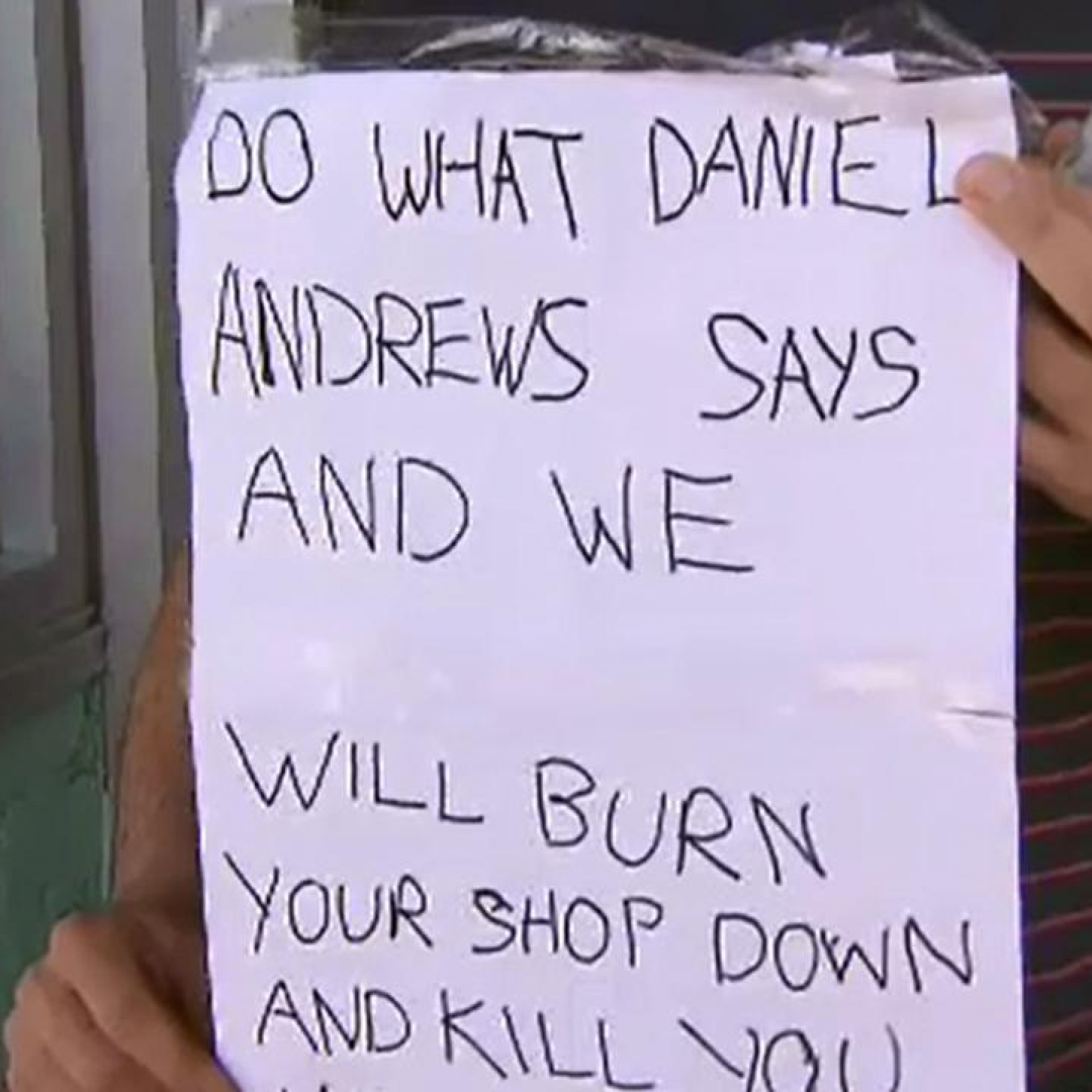Melbourne cafe owner Simon Kandias finds threatening note brick through window