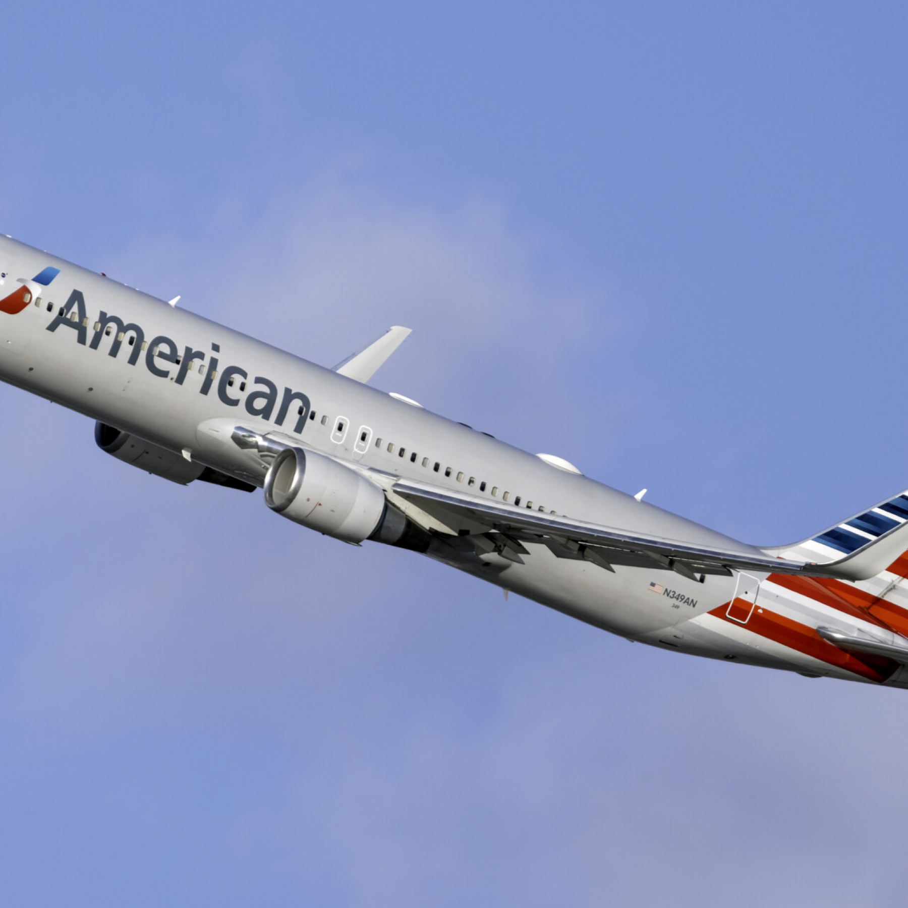 An American Airlines flight attendant hit an unruly passenger in the head with a coffee pot as he tried to open the planes exit door