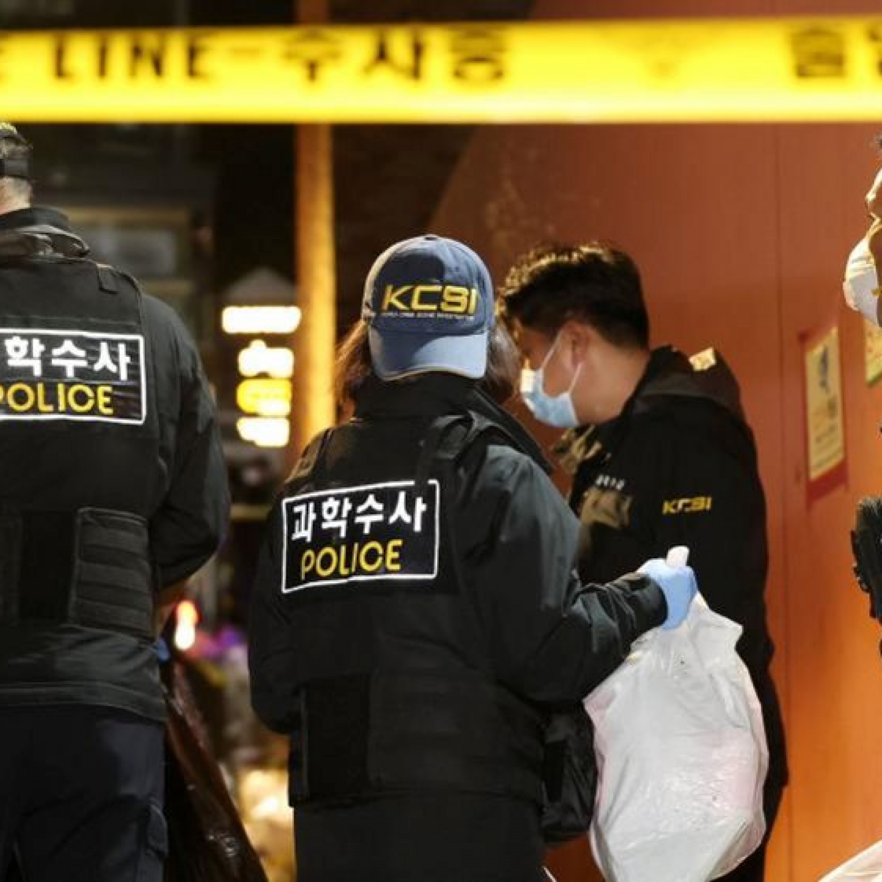 Two police officers walk down an alley in Itaewon two days after the crush that killed 156 people