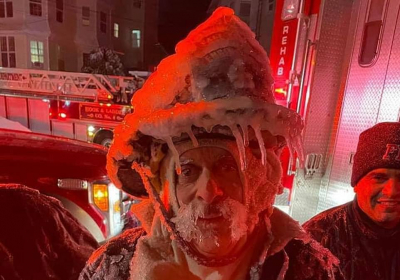 Firefighter is seen covered with icicles after fighting blaze during brutal Winter Storm Kenan