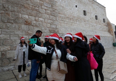 Tourists heading for the Church of Nativity in Bethlehem gather for a selfie